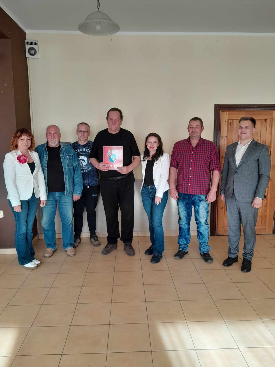 grupa ludzi stojących przy ścianie