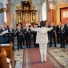 mężczyzna dyryguje chórem
