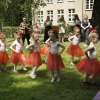 dziewczynki w kolorowych spódniczkach tańczą w parku