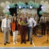 zdjęcie grupowe orkiestry dętej wraz z dyrygentem i przedstawicielami Organizatora