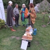 trzy kobiety i jeden mężczyzna stoją przy ławce