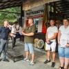grupa ludzi odbiera nagrody przy podium