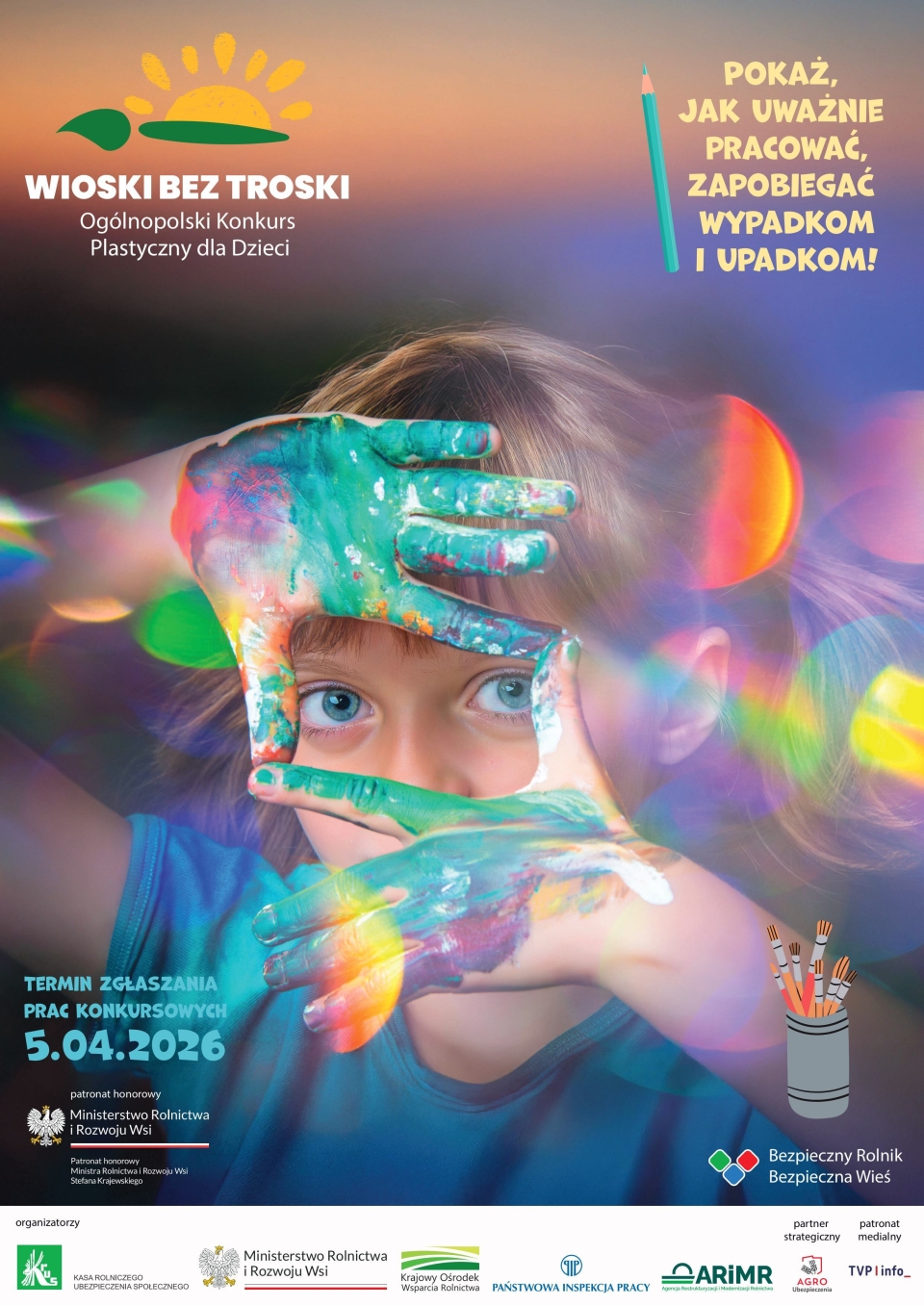 dziewczynka z pomalowanymi farbami rękoma robi ramkę z palców na wysokości swoich oczu