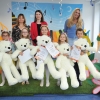 Na tle kolorowej scenografii jury z laureatami festiwalu pozują do zdjęcia