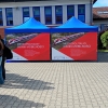 dwa namioty z banerem informacyjnym Metropolitalny Piknik Mobilności
